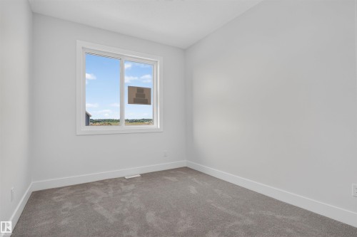 Neutral wall colors with white trim and grey carpeting - 84 Rosa Crescent, St. Albert, AB - Indoor Photo Showing Other Room