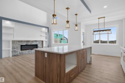 Spacious kitchen island with wood-finish cabinetry, white quartz countertop, and integrated storage - 