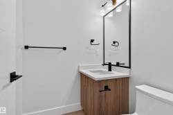 Modern vanity featuring a wood-finish cabinet, light countertop, and integrated sink - 