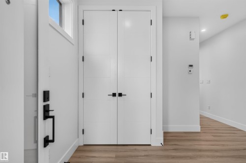 Entryway featuring a white door with modern black hardware and a transom window - 84 Rosa Crescent, St. Albert, AB - Indoor Photo Showing Other Room