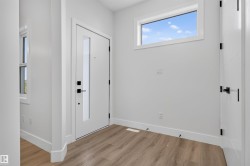 Entryway featuring a white door with a vertical glass insert, complemented by a rectangular transom window - 