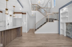 Open-concept living space with wood-finish flooring - 