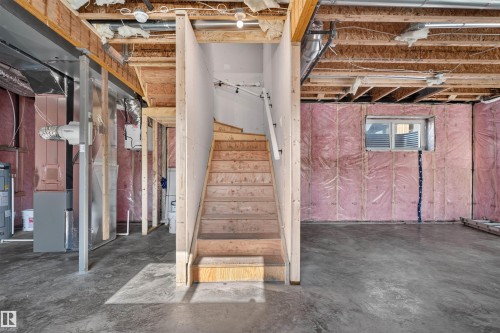 Unfinished basement offering substantial potential for customization, featuring exposed wood joists, concrete flooring, and a framed window opening - 84 Rosa Crescent, St. Albert, AB - Indoor Photo Showing Basement