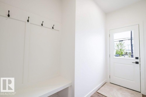 Built-in entryway bench with integrated storage and paneling - 5211 104A Street, Edmonton, AB 