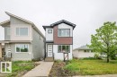 Modern architectural style featuring a multi-toned facade, large windows, and a prominent front entrance with a contemporary door - 5211 104A Street, Edmonton, AB 