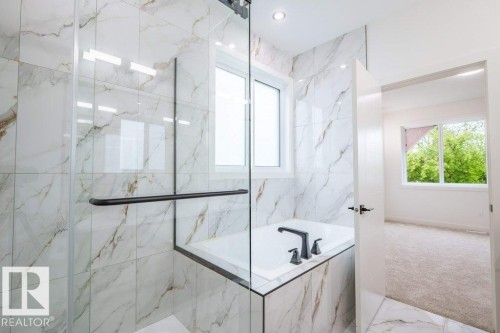 Bathroom featuring a tiled shower enclosure with a clear glass door, built-in bathtub, and matte black fixtures - 5211 104A Street, Edmonton, AB 