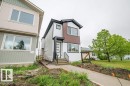 Modern facade featuring multi-tone siding, white trim, and a prominent dark roofline - 5211 104A Street, Edmonton, AB 