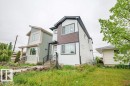 Contemporary two-story exterior with white siding and dark accent paneling - 5211 104A Street, Edmonton, AB 