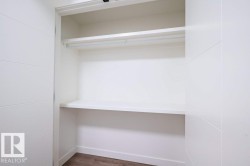 Recessed wardrobe with a hanging rod and two integrated shelves, finished in white - 