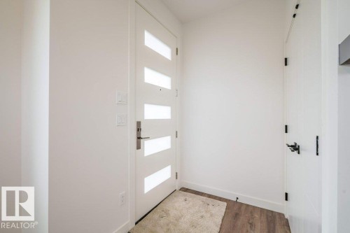 Modern entry door with horizontal frosted glass inserts and brushed nickel hardware - 5211 104A Street, Edmonton, AB 
