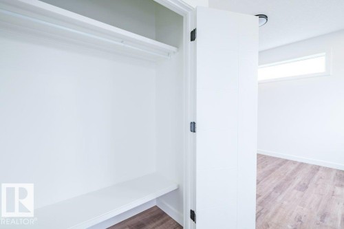 White closet featuring a clothing rod and lower shelf - 5211 104A Street, Edmonton, AB 