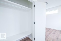 White closet featuring a clothing rod and lower shelf - 