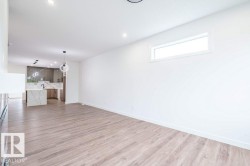 Spacious interior featuring wood-finish flooring, recessed lighting, and a horizontal window - 