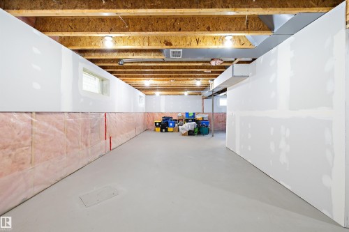 Unfinished basement featuring exposed wood joists and subfloor - 3344 24 Avenue, Edmonton, AB 