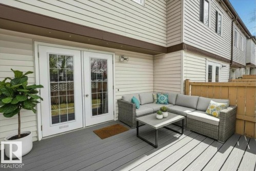 Private outdoor patio featuring gray composite decking - 14648 54 Street, Edmonton, AB 