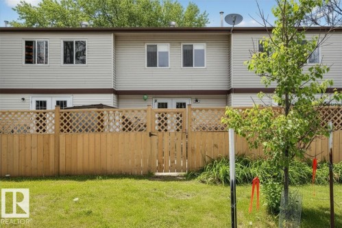 Private fenced yard featuring a wooden fence with lattice detailing and a gate - 14648 54 Street, Edmonton, AB 