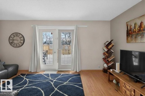 Living space featuring wood-finish flooring and neutral wall tones - 14648 54 Street, Edmonton, AB 