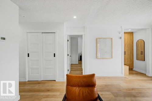 White walls with wood-finish flooring - 49 Galloway Drive, Sherwood Park, AB - Indoor Photo Showing Other Room
