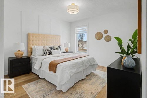 Neutral wall color with vertical accent trim, wood-finish flooring, and a large window with roller shades - 49 Galloway Drive, Sherwood Park, AB - Indoor Photo Showing Bedroom