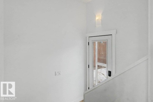 Glass-paned door with dark hardware, framed by white trim, providing access to exterior - 49 Galloway Drive, Sherwood Park, AB -  Photo Showing Other Room