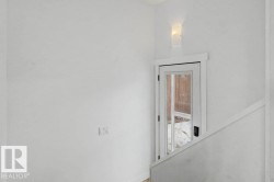 Glass-paned door with dark hardware, framed by white trim, providing access to exterior - 