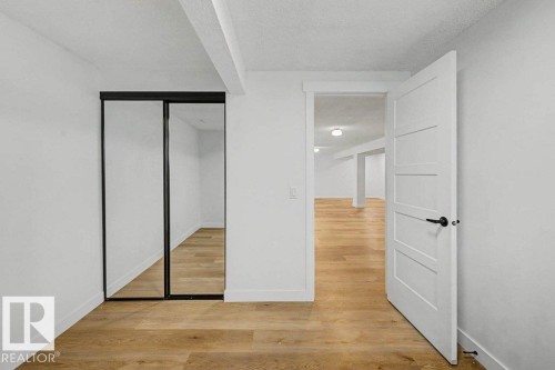 Room featuring wood-finish flooring, white walls, and a white ceiling - 49 Galloway Drive, Sherwood Park, AB - Indoor Photo Showing Other Room