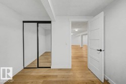 Room featuring wood-finish flooring, white walls, and a white ceiling - 