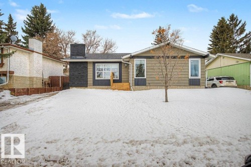 Ranch-style exterior with a dark stone-look chimney, light brown siding, and white trim windows - 49 Galloway Drive, Sherwood Park, AB - Outdoor