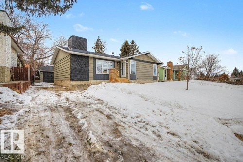 Ranch-style residence featuring horizontal siding, a prominent brick chimney, and a wooden front porch - 49 Galloway Drive, Sherwood Park, AB - Outdoor