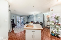 Kitchen island with a laminate countertop and white base cabinetry - 