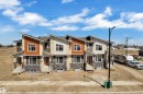 Modern townhome exteriors featuring varied siding textures, stone veneer accents, and contemporary rooflines - 175 Graybriar Drive, Stony Plain, AB 