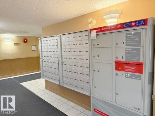 Mailbox area featuring multiple secure mailboxes and a parcel locker system - 218 5065 31 Avenue, Edmonton, AB 
