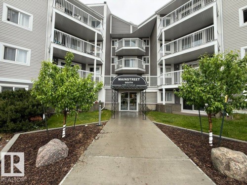 Multi-level building with gray siding and white trim - 218 5065 31 Avenue, Edmonton, AB 