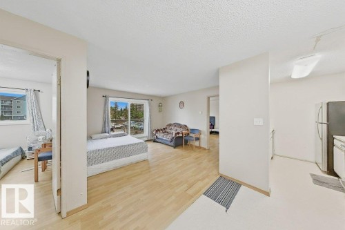 Open-concept living area with light-toned wood-finish flooring - 218 5065 31 Avenue, Edmonton, AB 