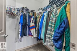 Walk-in closet featuring white wire shelving and hanging rods - 