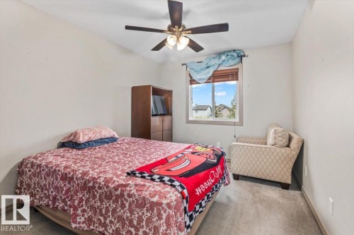 Neutral wall paint, ceiling fan with integrated lighting, window with blinds, and light gray carpeted flooring - 229 41 Summerwood Boulevard, Sherwood Park, AB - Indoor Photo Showing Bedroom