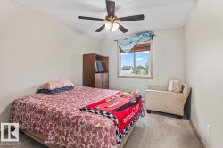 Neutral wall paint, ceiling fan with integrated lighting, window with blinds, and light gray carpeted flooring - 