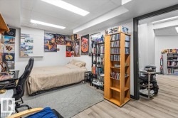 Neutral white walls frame a room featuring recessed lighting and light wood-finish flooring - 