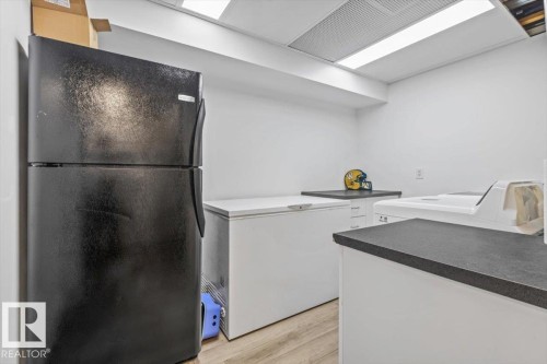 Utility room featuring wood-finish flooring, white walls, and a recessed ceiling light fixture - 229 41 Summerwood Boulevard, Sherwood Park, AB - Indoor
