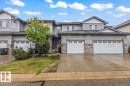 Multi-level townhome exterior featuring light gray siding and stone veneer accents - 229 41 Summerwood Boulevard, Sherwood Park, AB  - Outdoor With Facade 