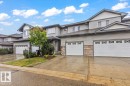 Townhome exterior featuring horizontal siding and stone veneer accents - 229 41 Summerwood Boulevard, Sherwood Park, AB  - Outdoor With Facade 