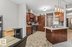 Kitchen featuring wood-finish cabinetry, stainless steel appliances, and a tiled backsplash - 