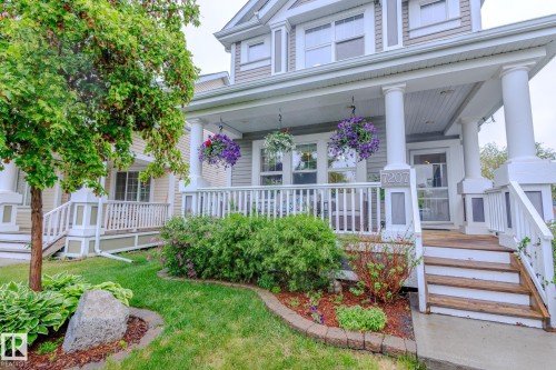 Classic front porch featuring white columns and railing - 7207 14A Avenue, Edmonton, AB - Outdoor With Deck Patio Veranda