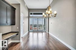 Open-concept living area with high ceilings and wood-finish flooring - 