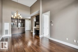 Hardwood-finish flooring extending through an open-concept living area with vaulted ceilings - 