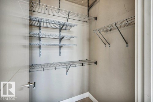 Closet interior featuring multiple levels of wire shelving and integrated hanging rods - 607 11080 Ellerslie Road, Edmonton, AB - Indoor With Storage