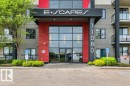 Modern building entrance featuring a prominent black canopy with "E•SCAPES" lettering - 607 11080 Ellerslie Road, Edmonton, AB  - Outdoor With Facade 