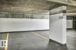 Dedicated parking space featuring a concrete floor, painted concrete walls, and overhead concrete ceiling - 