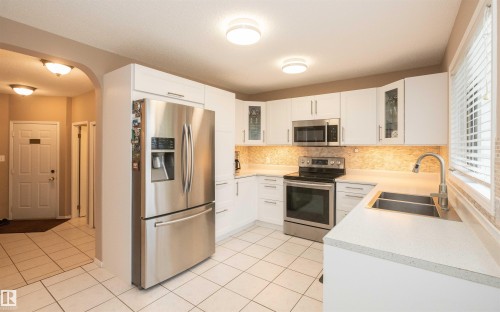 Bright kitchen featuring white cabinetry and stainless steel appliances - 10739 109 Avenue, Westlock, AB 