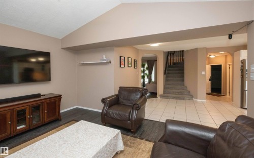 Living area with wood-finish flooring, vaulted ceiling, and recessed lighting - 10739 109 Avenue, Westlock, AB 
